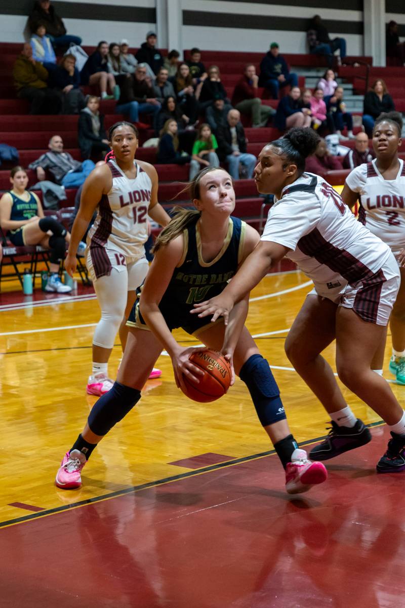 Eighth grader Alaria Tomidy fighting for possession.  Tomidy scored 8 points.  Photo by Steve Ognibene