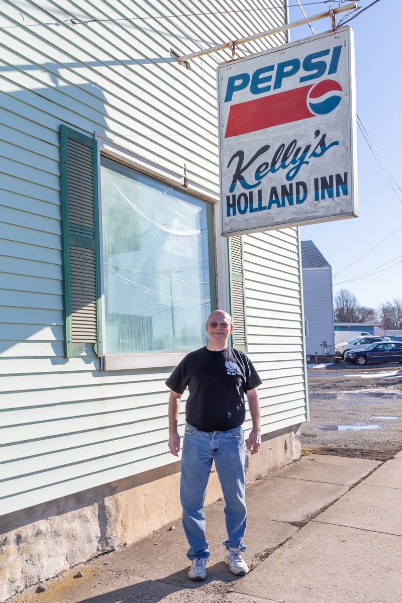 Kelly's Holland Inn sign with owner Gerry.  Photo by Steve Ognibene