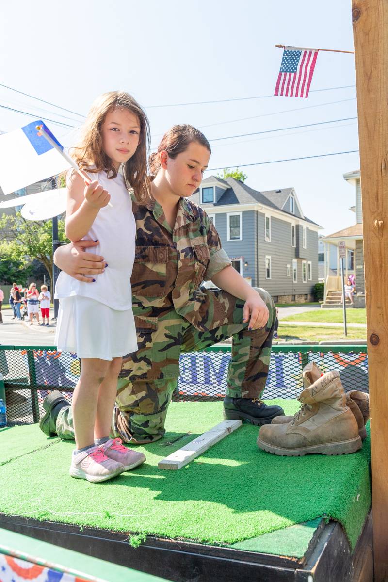 A soldier bowing to a falling soldier in a parade float, Batavia Memorial Day Parade