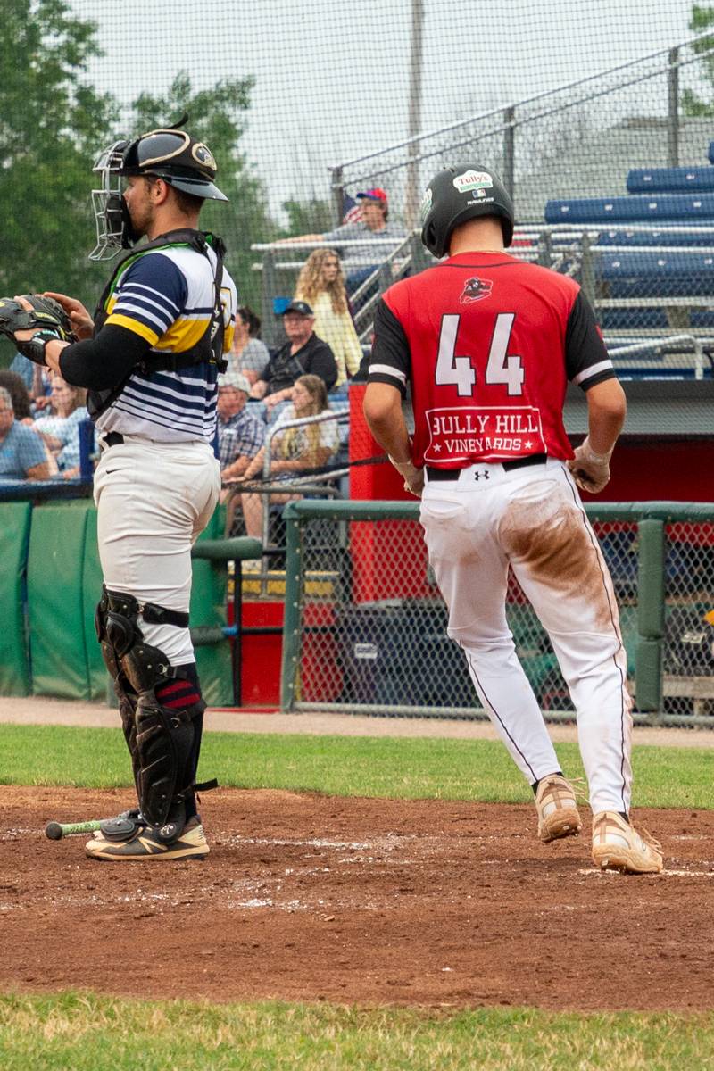 Muckdogs player scoring a much needed run. Photo by Steve Ognibene