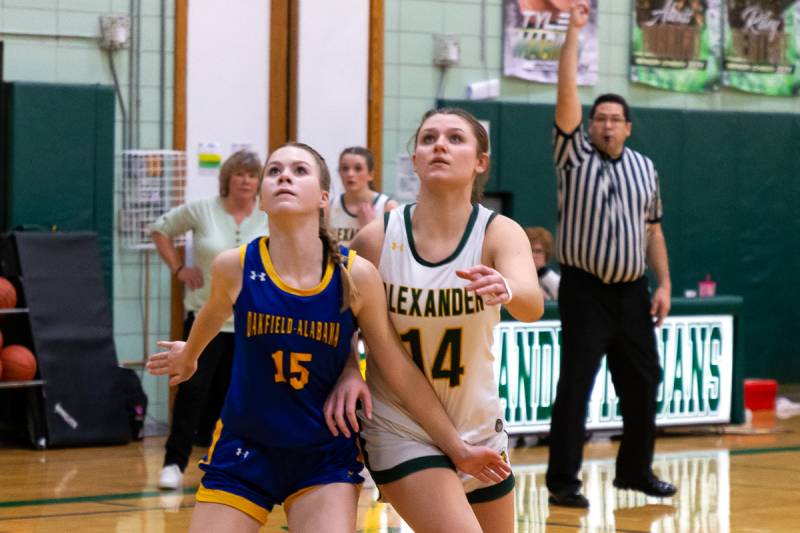 Looking for the rebound.  Two genesee County teams battling it out at Alexander High School.  Photo by Steve Ognibene