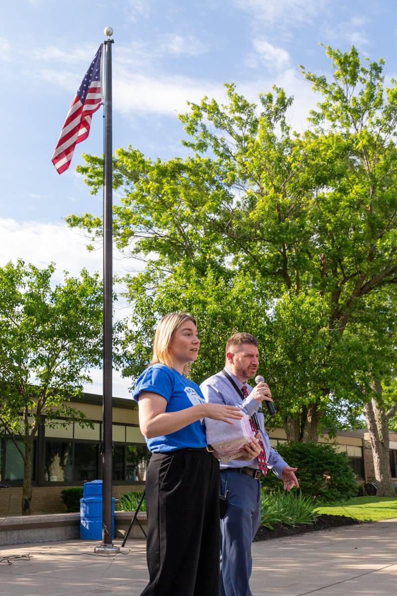 John Kennedy Intermediate principal Paul Kessler and assistant principal Heather McCarthy have morning announcements outside with students for Flag Day.  Photo by Steve Ognibene