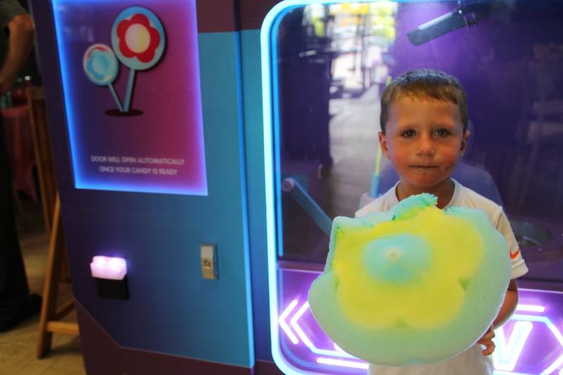 Kid with flower cotton candy at House of Bounce