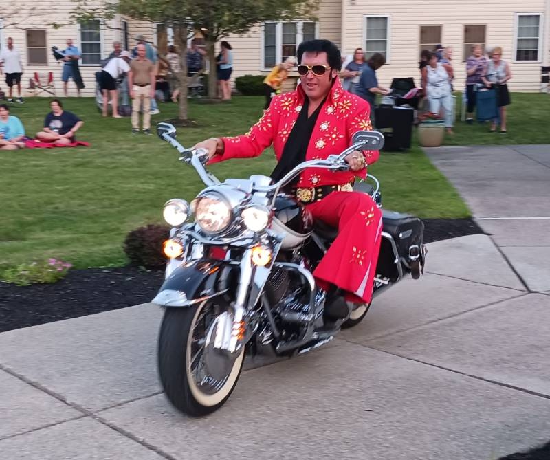 Terry Buchwald in red on motorcycle