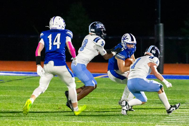 Quarterback Bronx Bucholtz on the move to gain yards in a running game because of high winds last evening at VanDetta stadium.  Photo by Steve Ognibene