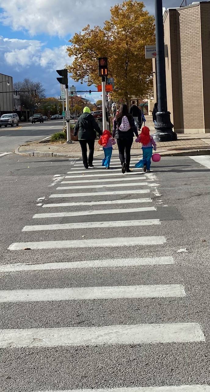 Mermaid trick or treaters on crosswalk