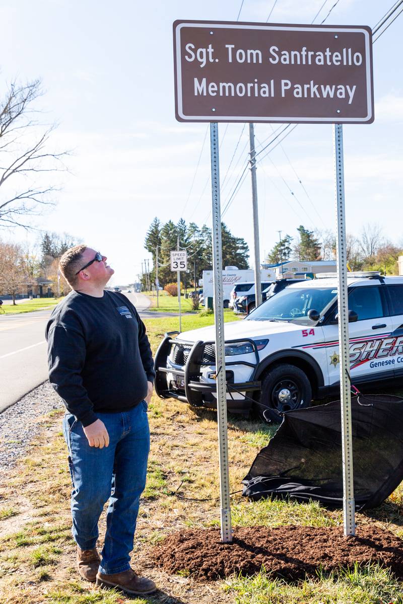 Sgt. SanFratello's son Ian helps unveil a Memorial Parkway sign honoring his dad.  Photo by Steve Ognibene