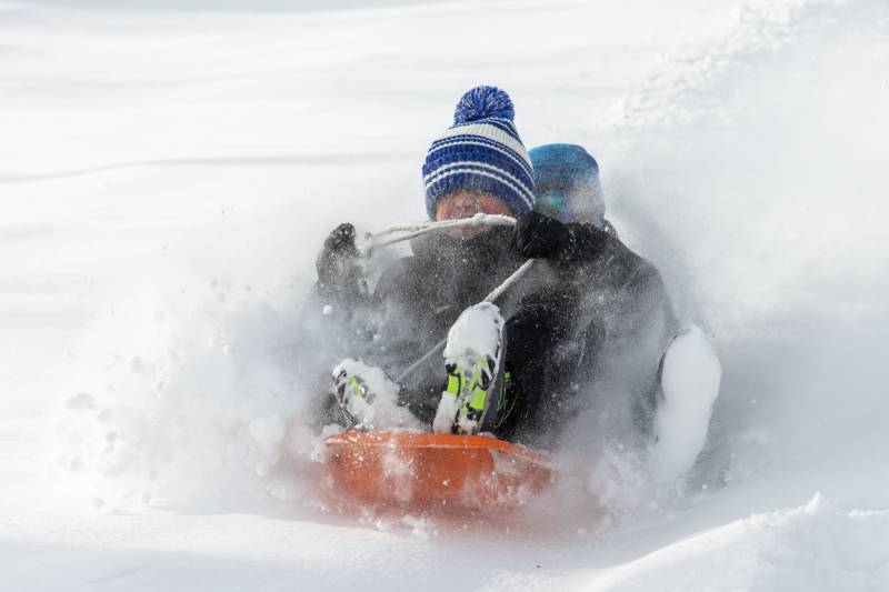 Jackson and Troy Briggs enjoy their day off of school sledding down South Jackson St. bridge, Batavia.  Photo by Steve Ognibene