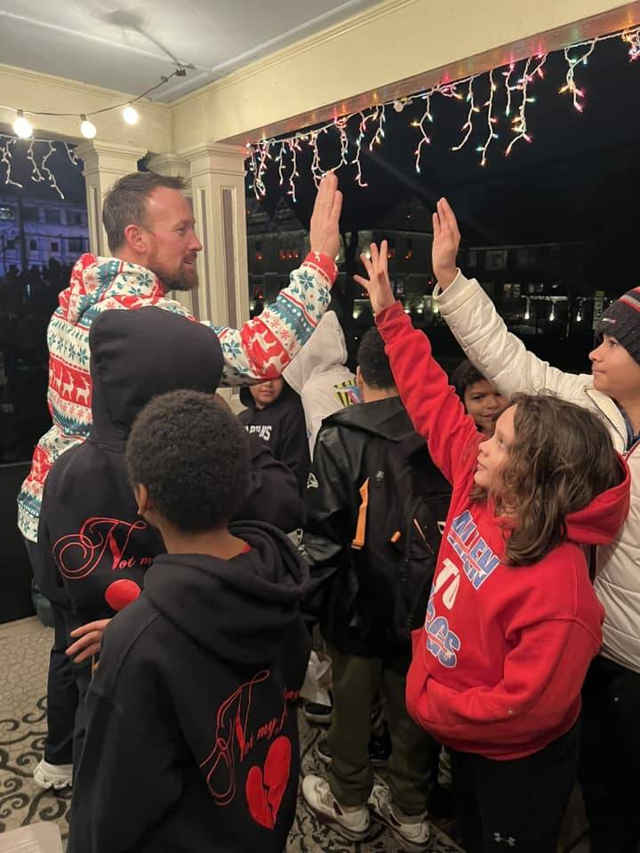 BMS caroling on porch high five