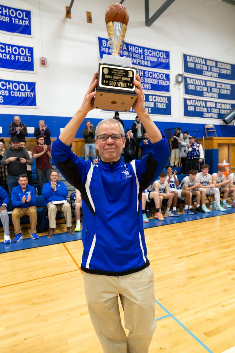 Coach Brasky celebrating his 500th career win with a trophy presented by Superintendent Jason Smith.  Photo by Steve Ognibene