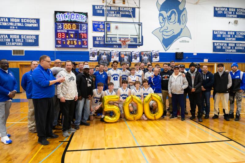 Coach Buddy Brasky pictured with his team, former students, parents now helped celebrate his 500th career win over Eastridge 83-79 at Batavia High School Friday evening.  Photo by Steve Ognibene