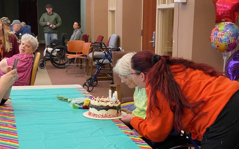 Eleanor Davis with Teressa Monroe blowing out candles