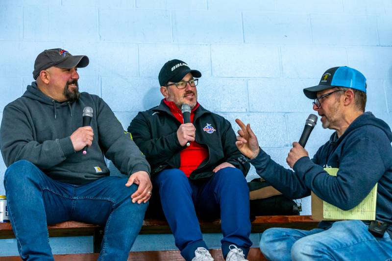 Radio Broadcaster Steven Pies, announcing the game for 1490 WBTA, interviews Guy and joe Pellegrino from Pellegrino Auto Sales during the second intermission.  Photo by Steve Ognibene